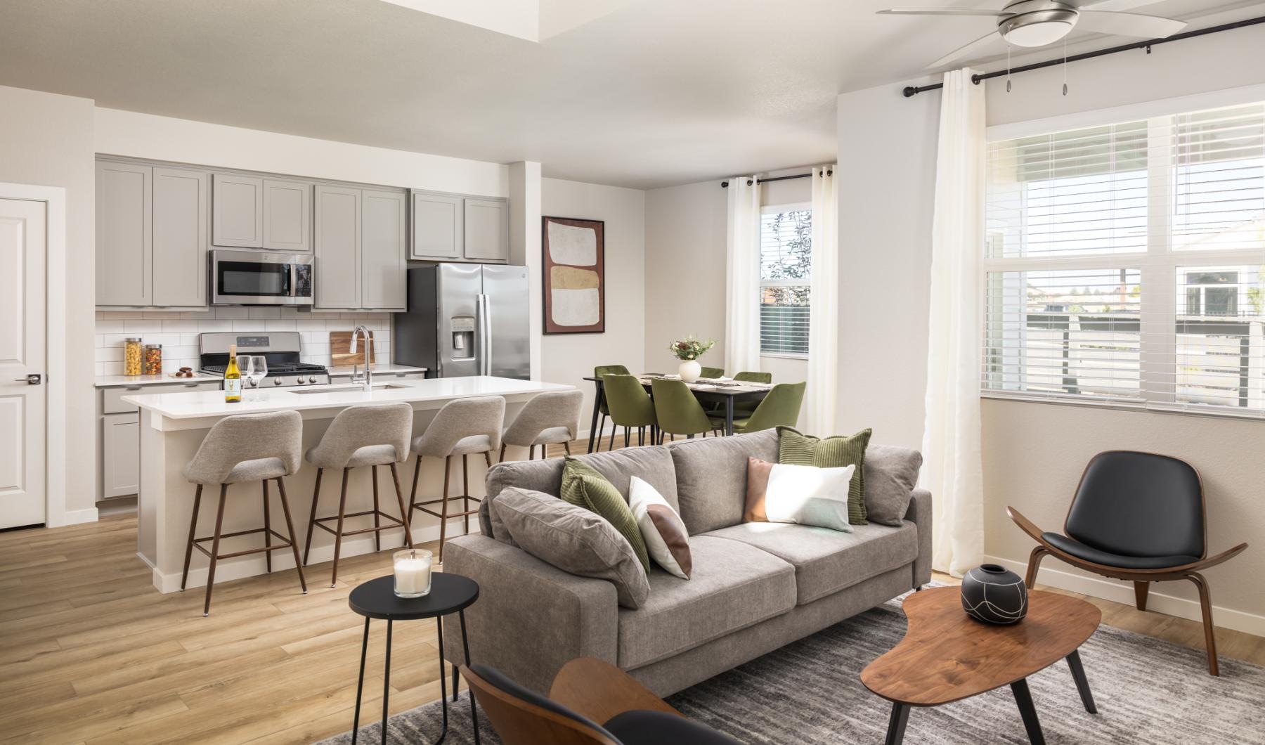 sunlit living room open to kitchen