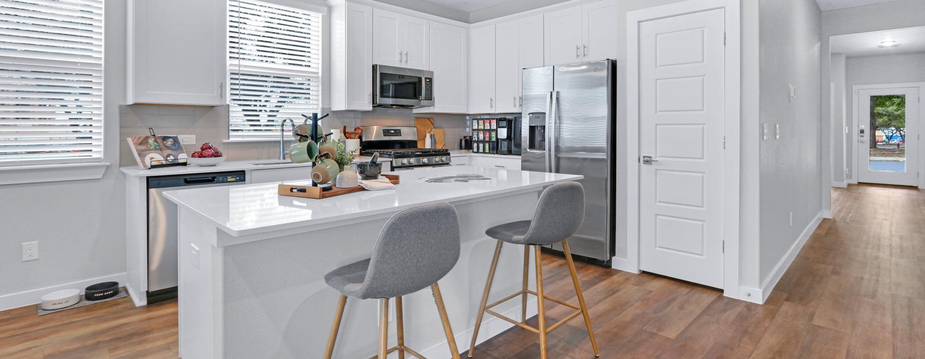 large kitchen with island and large windows